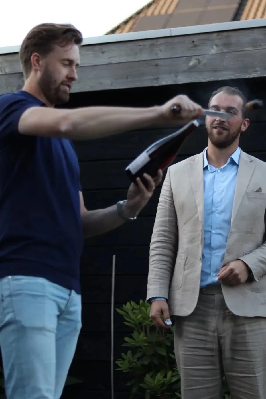 Sabragemoment bij Rob thuis — champagnefles wordt gesabreerd